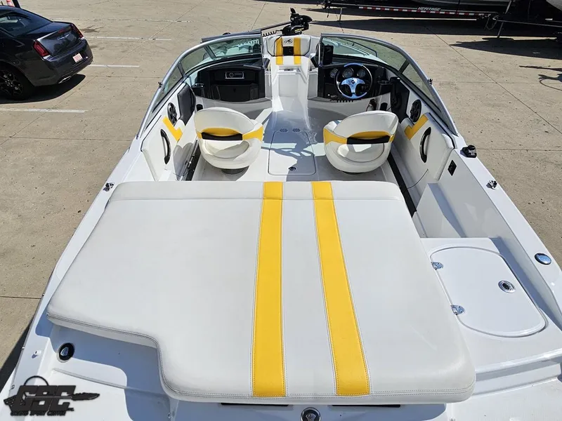 Slide: The Image of 2015 Monterey 196MFS boat interior with yellow-striped seating and modern dashboard. - 46