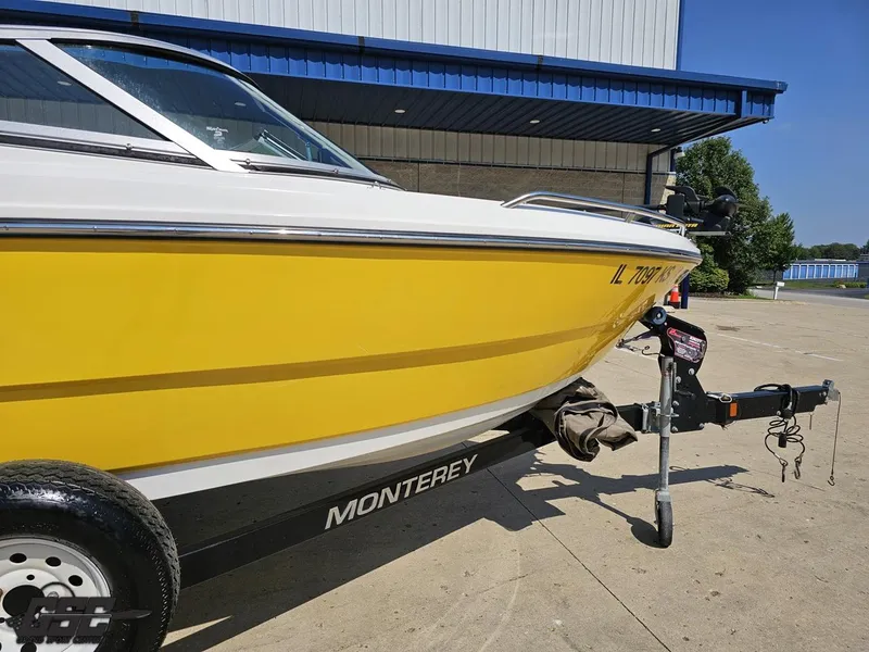 Slide: The Image of Yellow 2015 Monterey 196MFS boat on trailer, parked outdoors near a building. - 6