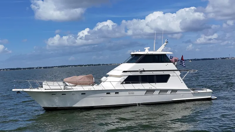 Slide: The Image of 1988 Hatteras Enclosed Bridge Sportfish yacht on open water under blue sky. - 14