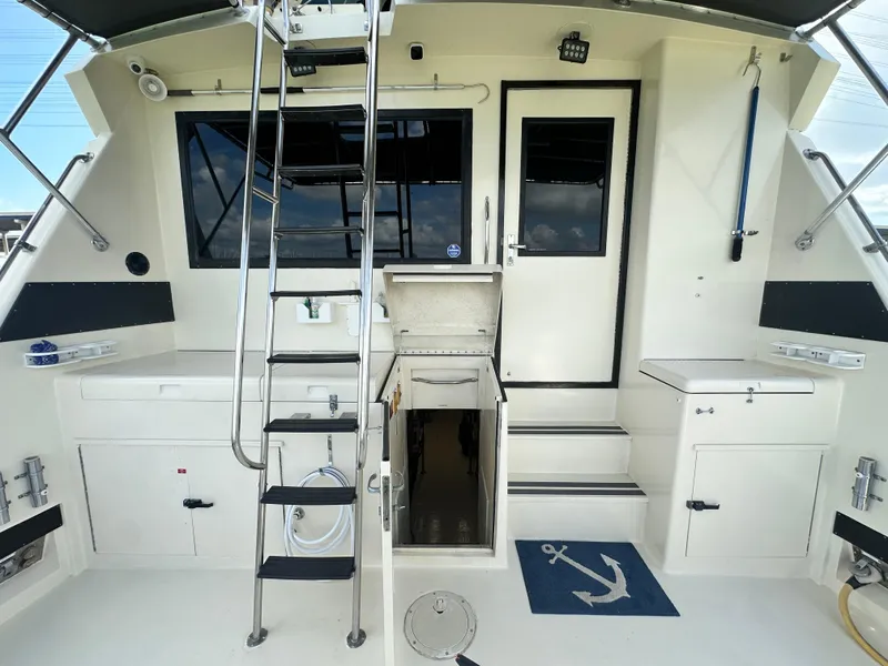 Slide: The Image of 1988 Hatteras Enclosed Bridge Sportfish boat interior with ladder and storage compartments. - 18