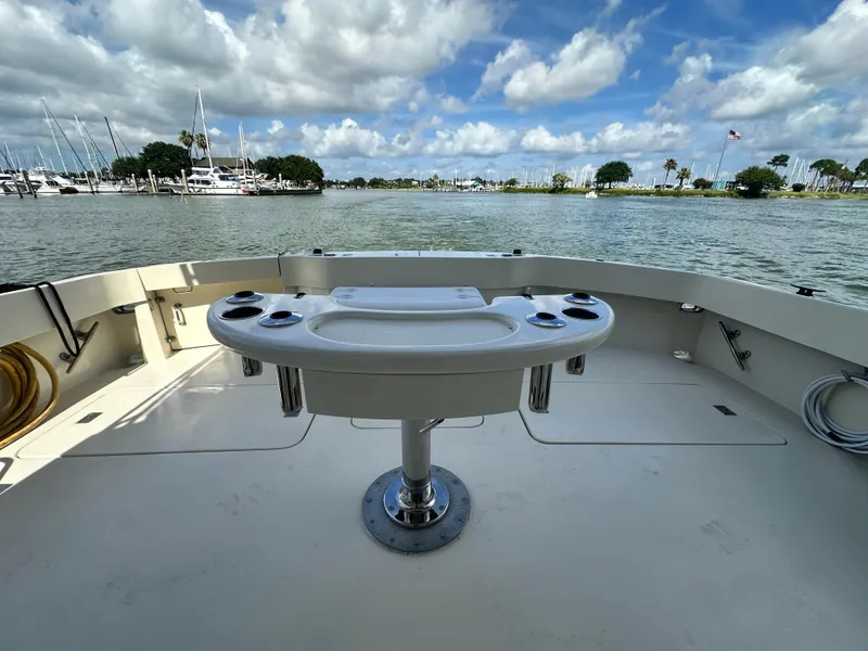 Slide: The Image of 1988 Hatteras Enclosed Bridge Sportfish boat deck with fishing station, marina view. - 21