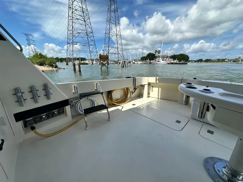 Slide: The Image of 1988 Hatteras Enclosed Bridge Sportfish boat deck with scenic waterfront view. - 22
