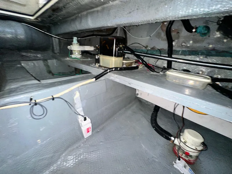 Slide: The Image of 1988 Hatteras Enclosed Bridge Sportfish engine room with wiring and equipment. - 36