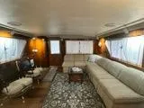 Slide: The Image of Luxurious interior of 1988 Hatteras Enclosed Bridge Sportfish with elegant seating and decor. - 42