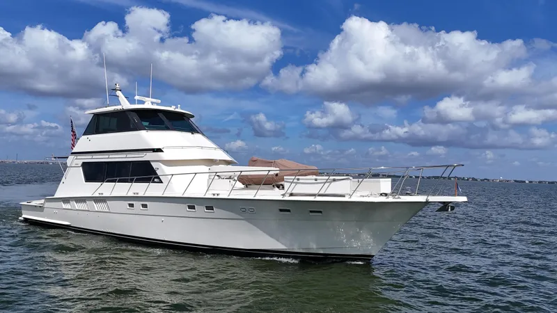 Slide: The Image of 1988 Hatteras Enclosed Bridge Sportfish yacht cruising on a sunny day with blue skies. - 8