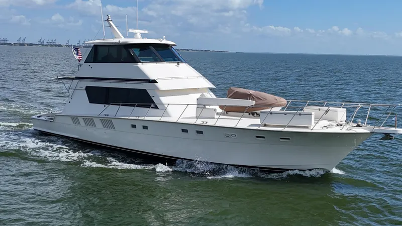 Slide: The Image of 1988 Hatteras Enclosed Bridge Sportfish yacht cruising on open water. - 10