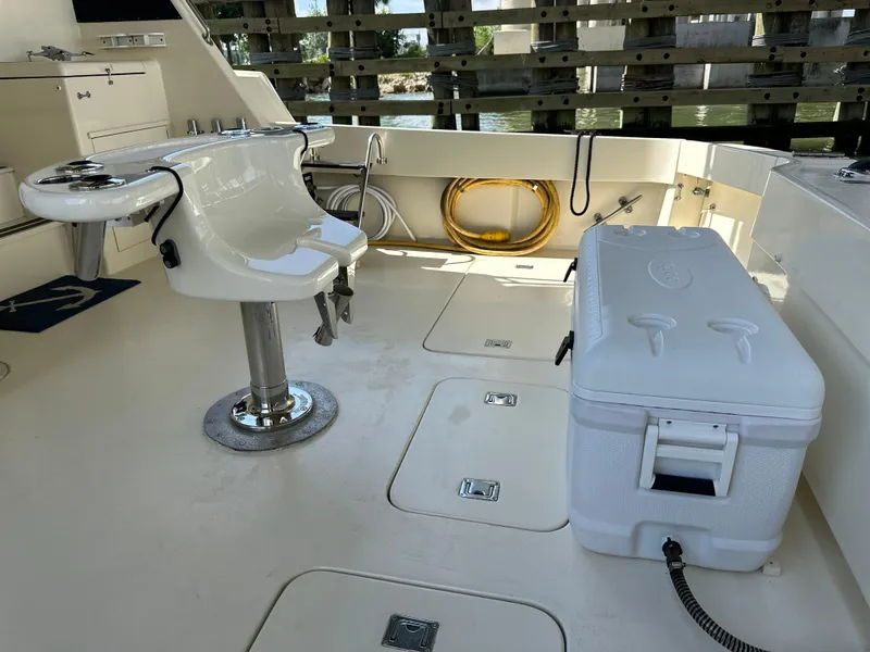 Slide: The Image of 1988 Hatteras Enclosed Bridge Sportfish deck with fishing chair and cooler. - 24