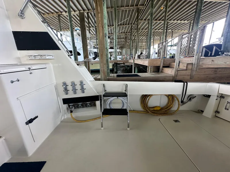 Slide: The Image of 1988 Hatteras Enclosed Bridge Sportfish boat deck with storage and equipment. - 25