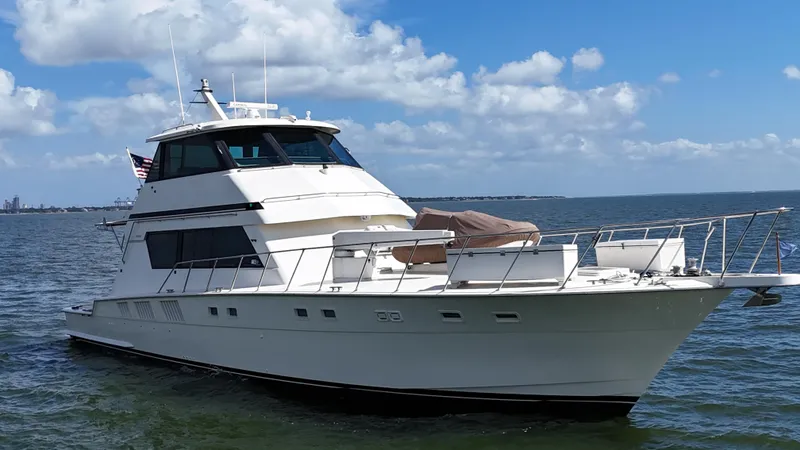 Slide: The Image of 1988 Hatteras Enclosed Bridge Sportfish yacht on open water under a blue sky. - 3