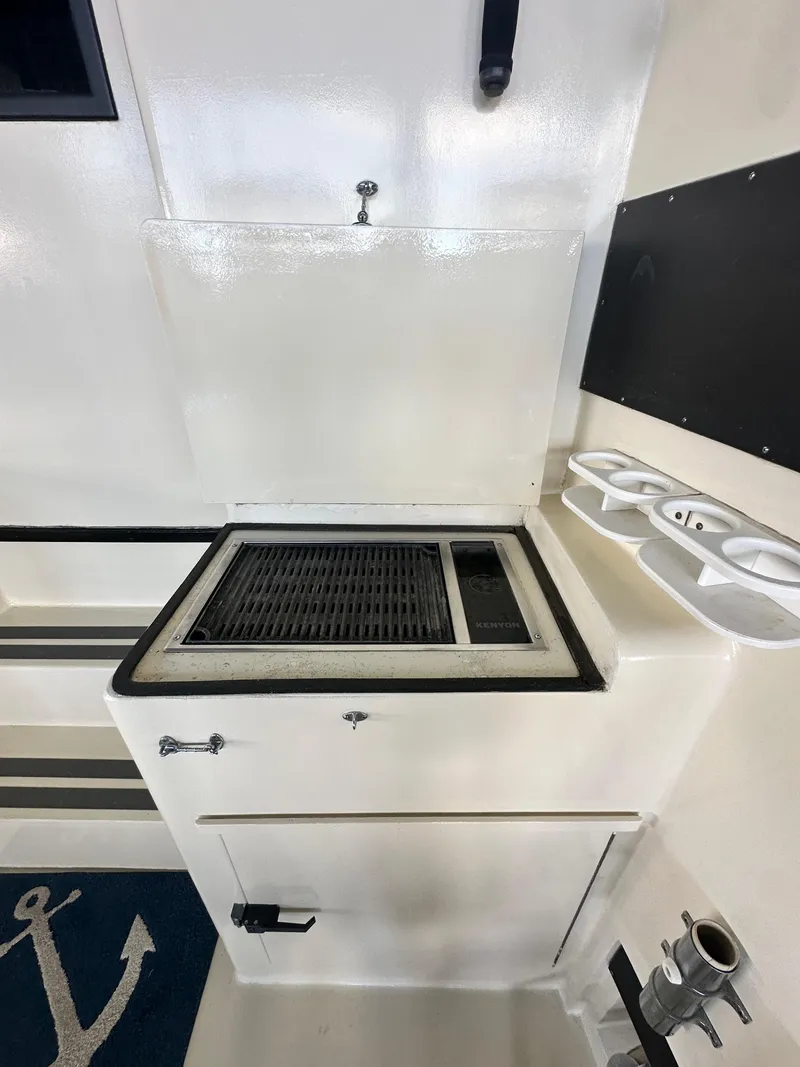 Slide: The Image of 1988 Hatteras Enclosed Bridge Sportfish interior with grill and storage compartments. - 33