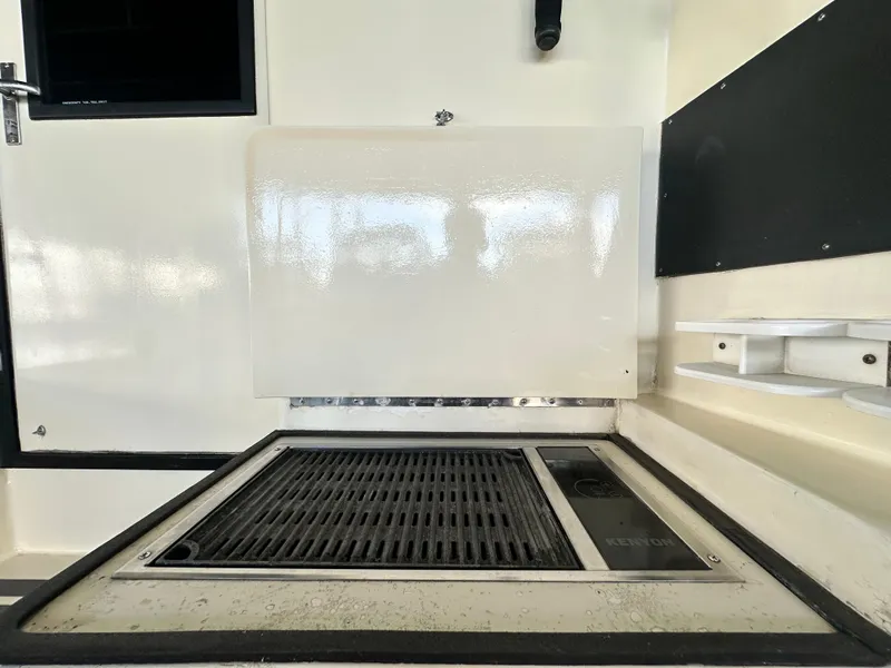 Slide: The Image of 1988 Hatteras Enclosed Bridge Sportfish grill area with Kenyon cooktop. - 34