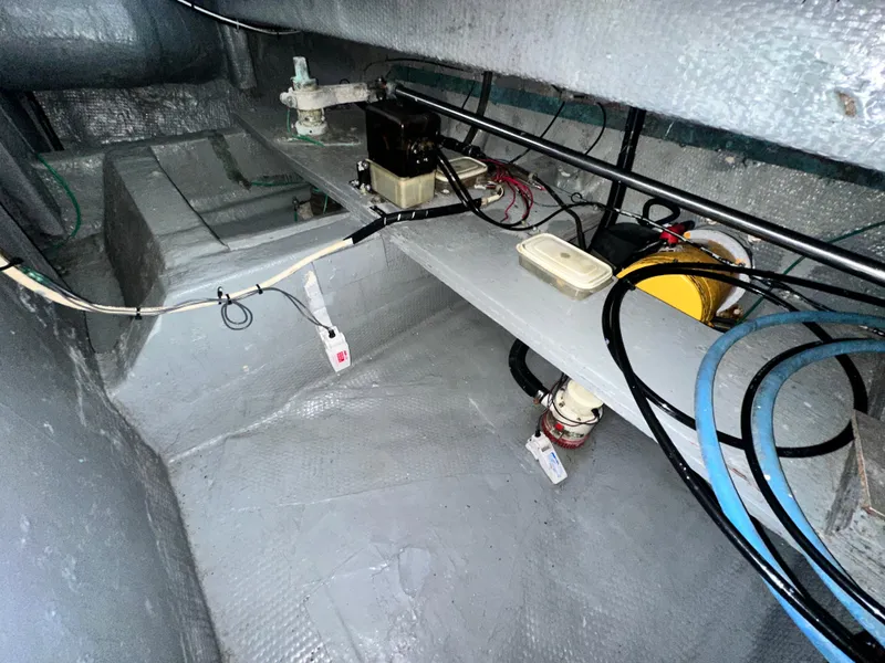 Slide: The Image of 1988 Hatteras Enclosed Bridge Sportfish engine room with wiring and equipment. - 35