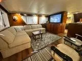 Slide: The Image of Luxurious interior of 1988 Hatteras Enclosed Bridge Sportfish with cozy seating and large TV. - 39