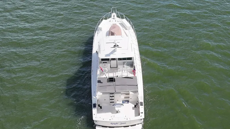 Slide: The Image of 1988 Hatteras Enclosed Bridge Sportfish yacht cruising on open water, aerial view. - 5
