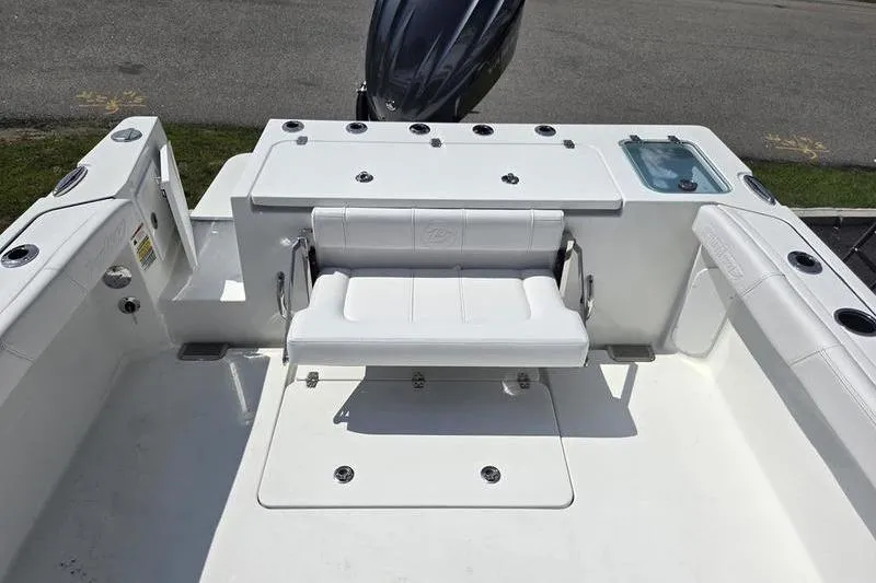 Slide: The Image of 2026 Parker 2220 SPORT CABIN boat interior with seating and storage compartments. - 10