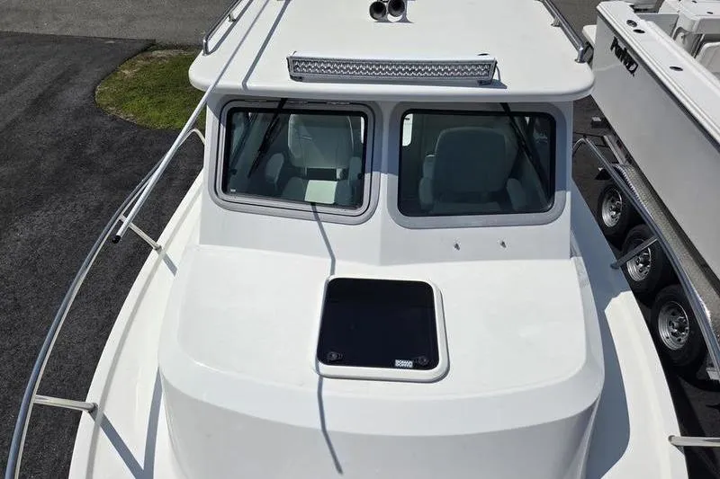 Slide: The Image of 2026 Parker 2220 Sport Cabin boat, top view showing cabin windows and deck hatch. - 13