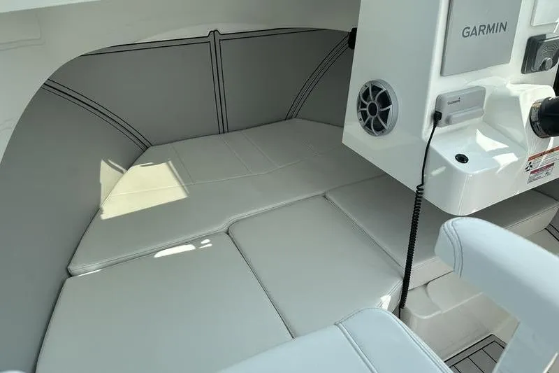 Slide: The Image of 2026 Parker 2220 SPORT CABIN interior with cushioned seating and Garmin equipment. - 16