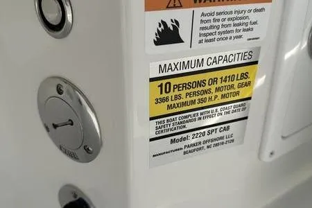 Slide: The Image of Warning label on 2026 Parker 2220 SPORT CABIN boat, showing maximum capacity and safety information. - 18