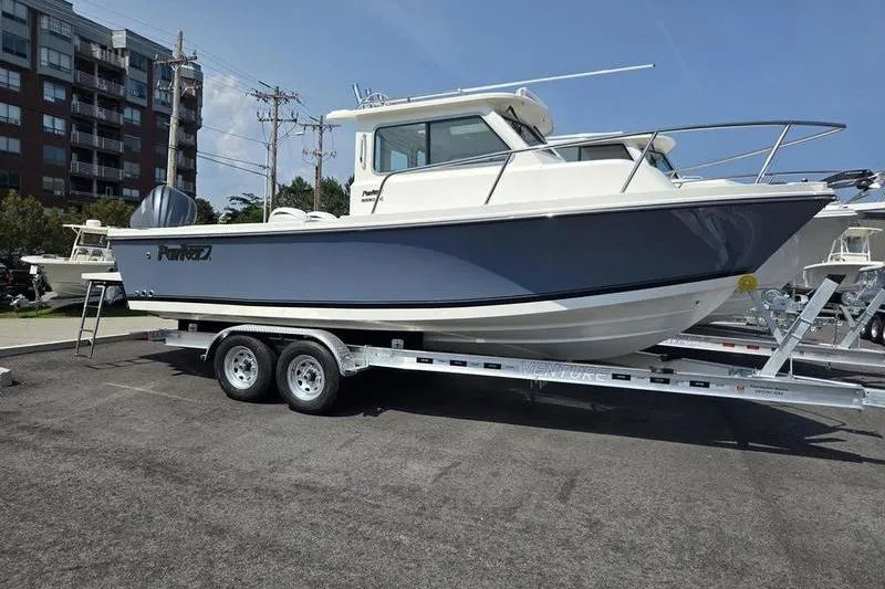 The Image of 2026 Parker 2220 Sport Cabin boat on trailer, parked outdoors. - 3