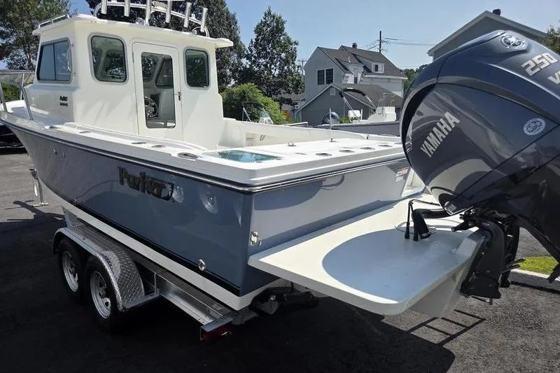 Slide: The Image of 2026 Parker 2220 Sport Cabin boat with Yamaha engine on trailer. - 9