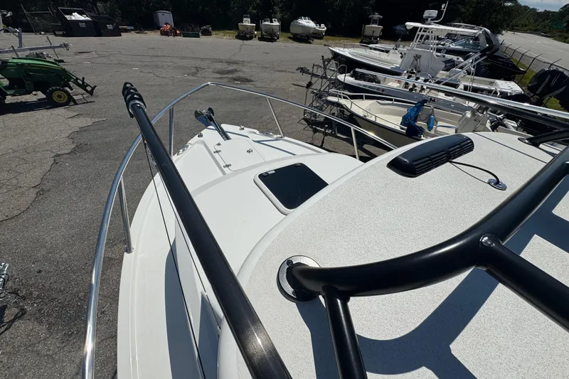 Slide: The Image of 2025 Parker 2220 SC boat on display in a marina with other vessels. - 10