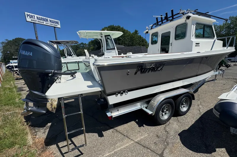 Slide: The Image of 2025 Parker 2220 SC boat with Yamaha engine at Port Harbor Marine dealership. - 2