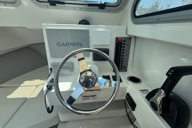 Slide: The Image of Helm of 2025 Parker 2220 SC boat with Garmin navigation system and control panel. - 4