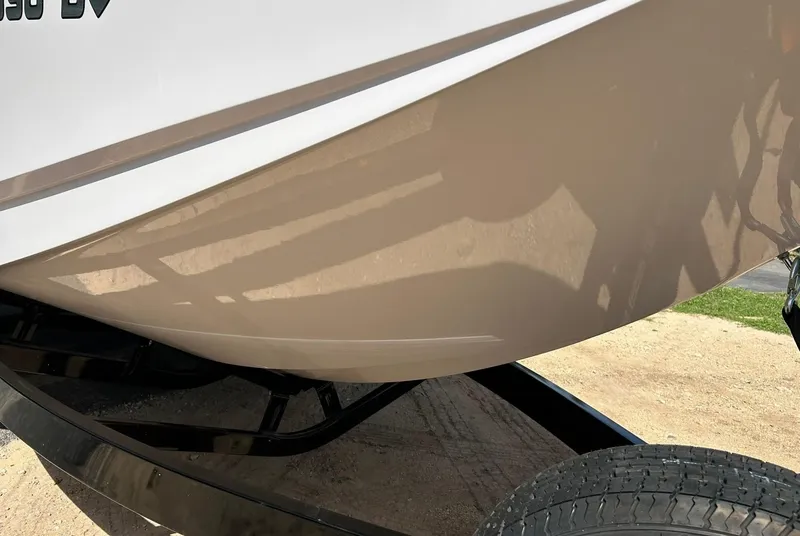 Slide: The Image of 2014 Nautique Super Air Nautique G23 boat hull on trailer, close-up view. - 12