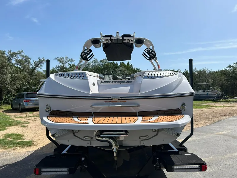 Slide: The Image of 2014 Nautique Super Air Nautique G23 boat on trailer, rear view, sunny day. - 20