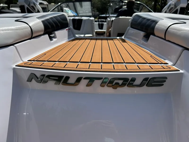 Slide: The Image of 2014 Nautique Super Air Nautique G23 boat with teak deck and logo. - 28