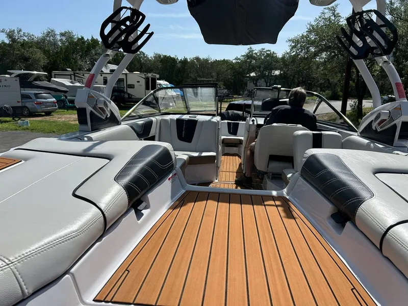 Slide: The Image of 2014 Nautique Super Air Nautique G23 interior with teak flooring and cushioned seating. - 30