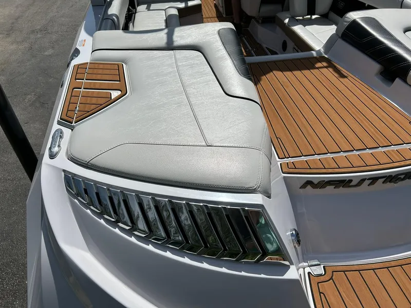 Slide: The Image of 2014 Nautique Super Air Nautique G23 boat with sleek seating and teak-style decking. - 31