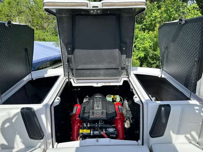Slide: The Image of 2014 Nautique Super Air Nautique G23 engine compartment with open hatches, showcasing PCM engine. - 34