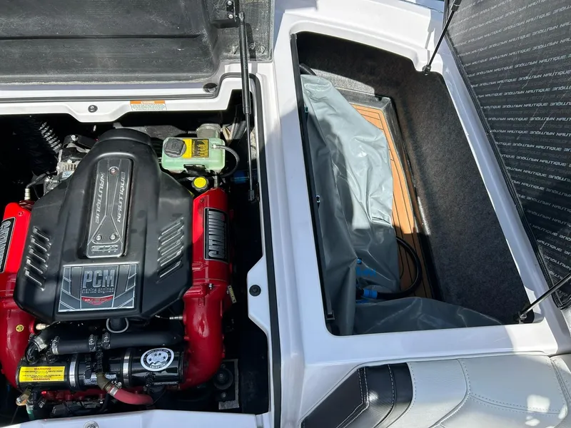 Slide: The Image of 2014 Nautique Super Air Nautique G23 engine compartment with PCM engine and storage area. - 36