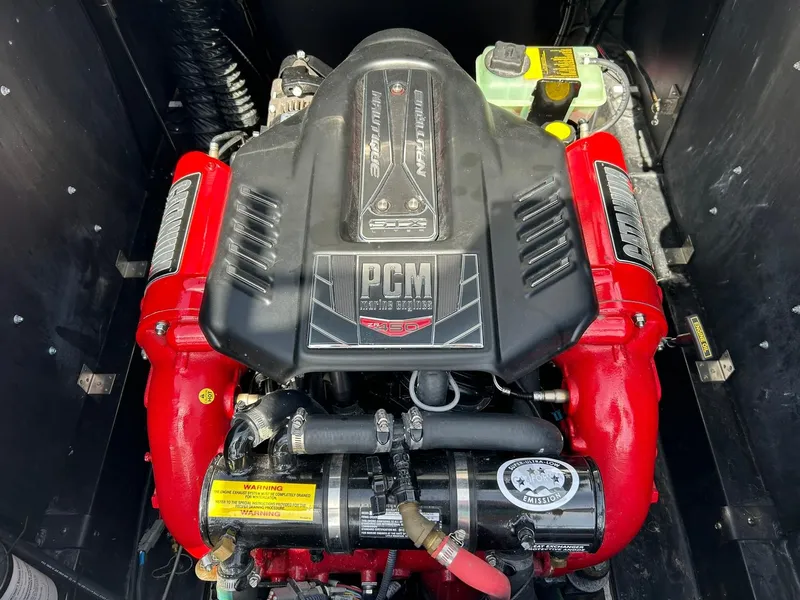 Slide: The Image of 2014 Nautique Super Air Nautique G23 engine with red components and PCM branding. - 38