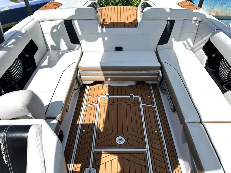 Slide: The Image of 2014 Nautique Super Air Nautique G23 interior with white seating and teak flooring. - 39