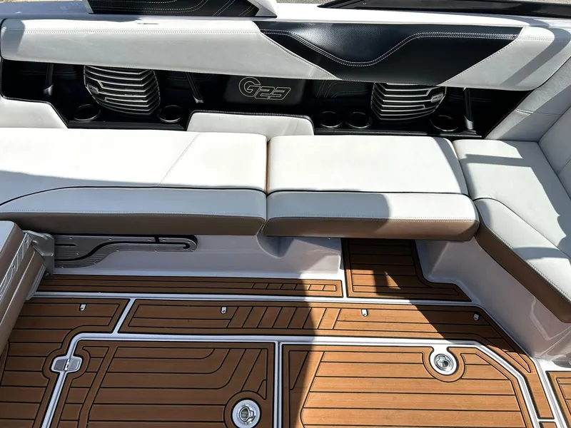 Slide: The Image of 2014 Nautique Super Air Nautique G23 interior with cushioned seating and teak-style flooring. - 45