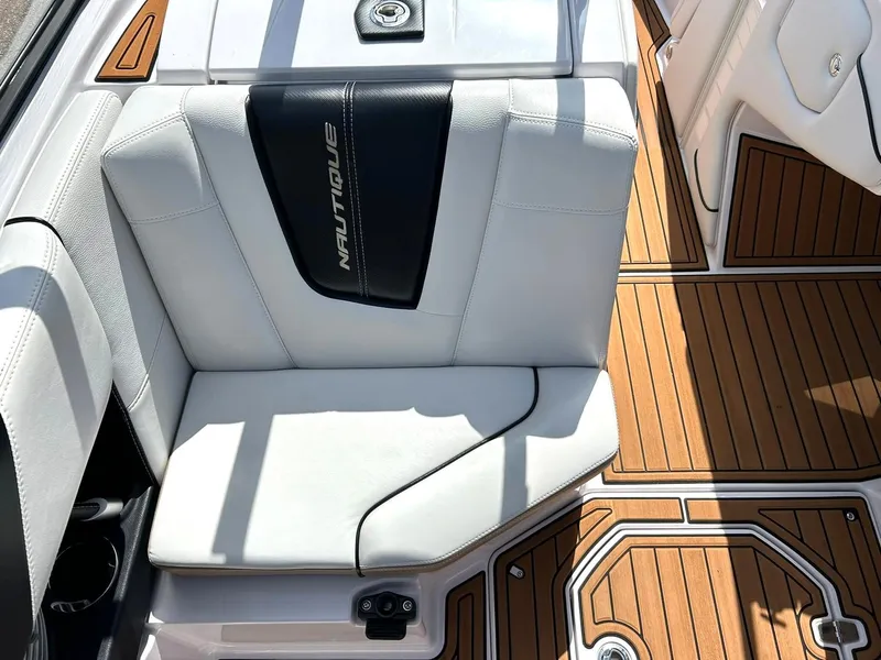 Slide: The Image of 2014 Nautique Super Air Nautique G23 interior with white seating and teak flooring. - 48