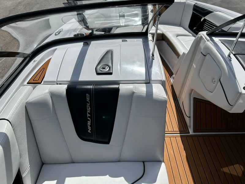 Slide: The Image of 2014 Nautique Super Air Nautique G23 interior with white seating and teak flooring. - 49