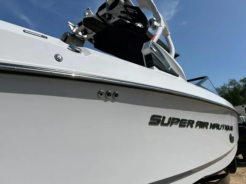 Slide: The Image of 2014 Nautique Super Air Nautique G23 boat, sleek design, close-up view, sunny day. - 8
