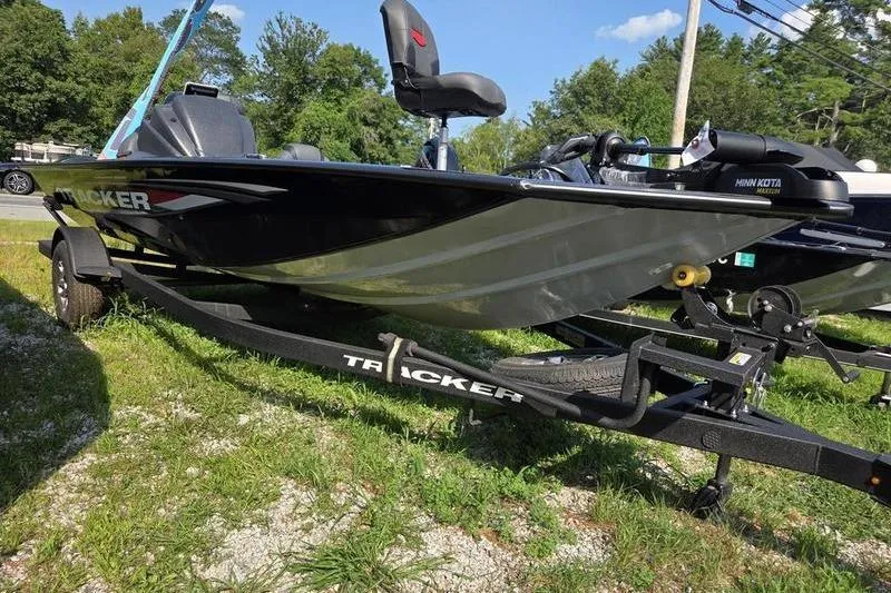 The Image of 2026 Tracker PT 195 TXW TE boat on trailer, parked on grass. - 2