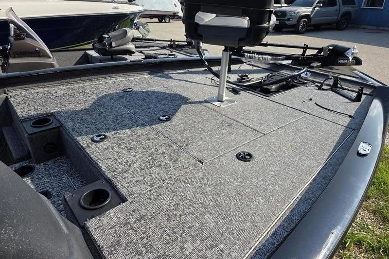 Slide: The Image of 2026 Tracker PT 195 TXW TE boat deck with seating and fishing equipment. - 6