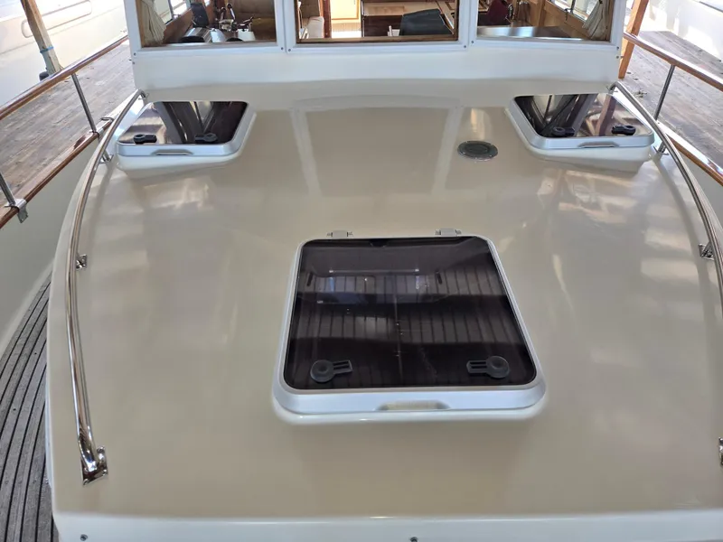 Slide: The Image of 1990 Grand Banks 36 Europa yacht deck with hatches and railing. - 16