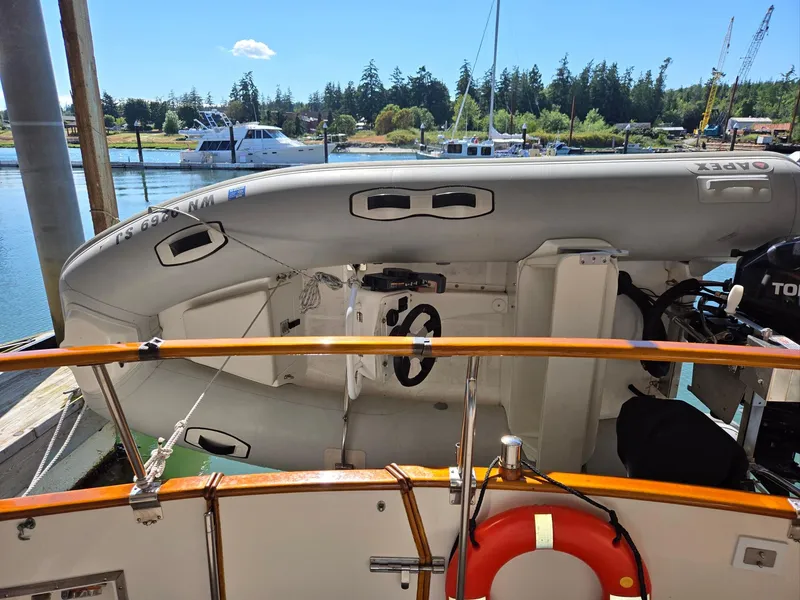Slide: The Image of Inflatable boat on Grand Banks 36 Europa, 1990, docked with scenic marina background. - 21