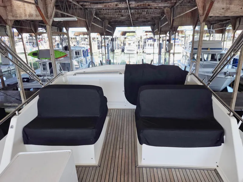 Slide: The Image of Covered seating area on a 1990 Grand Banks 36 Europa yacht in a marina. - 25