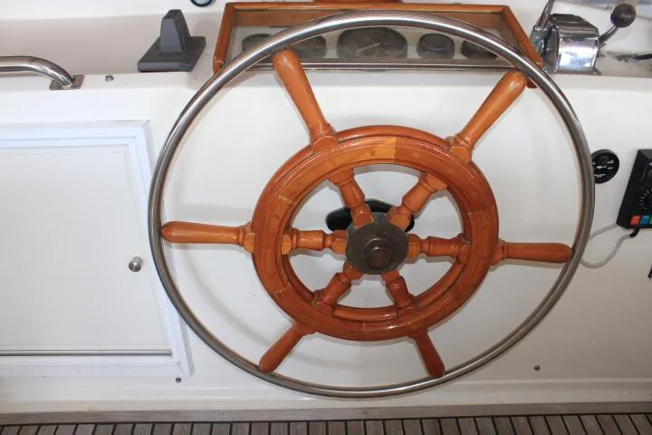 Slide: The Image of Wooden steering wheel on a 1990 Grand Banks 36 Europa yacht. - 28
