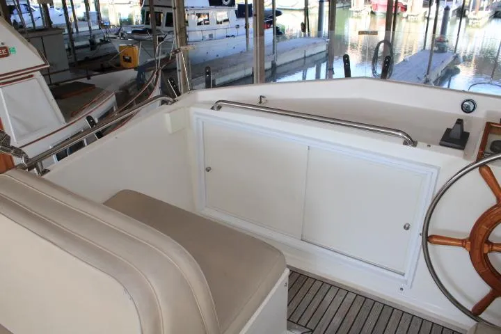 Slide: The Image of Interior view of 1990 Grand Banks 36 Europa yacht with wooden steering wheel and seating. - 32
