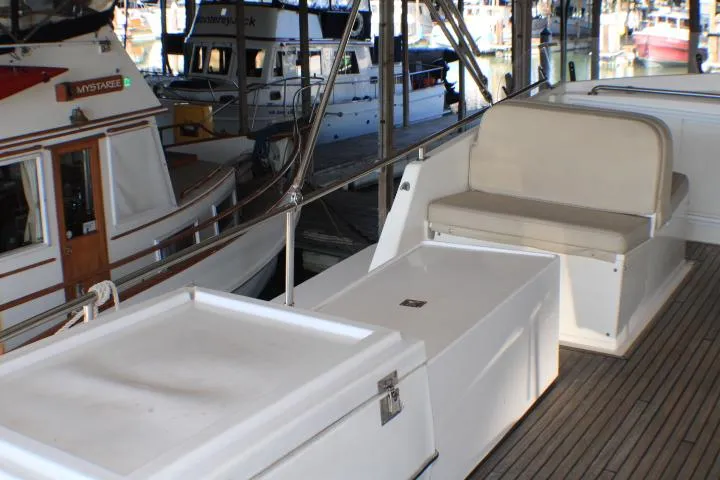 Slide: The Image of 1990 Grand Banks 36 Europa yacht interior with seating and storage, docked in a marina. - 33