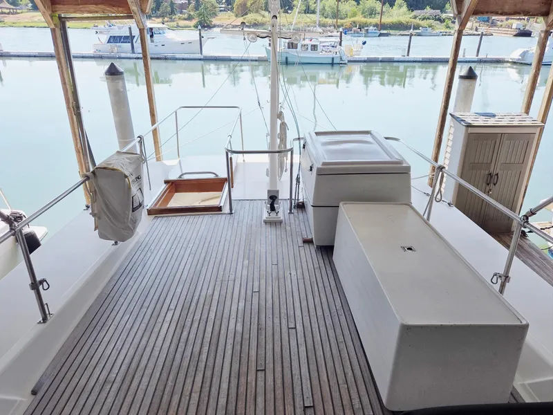 Slide: The Image of 1990 Grand Banks 36 Europa yacht deck with wooden flooring, docked at a marina. - 34