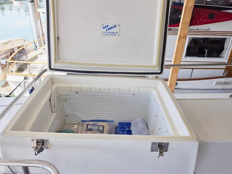 Slide: The Image of Open freezer on 1990 Grand Banks 36 Europa yacht, containing food and ice packs. - 36